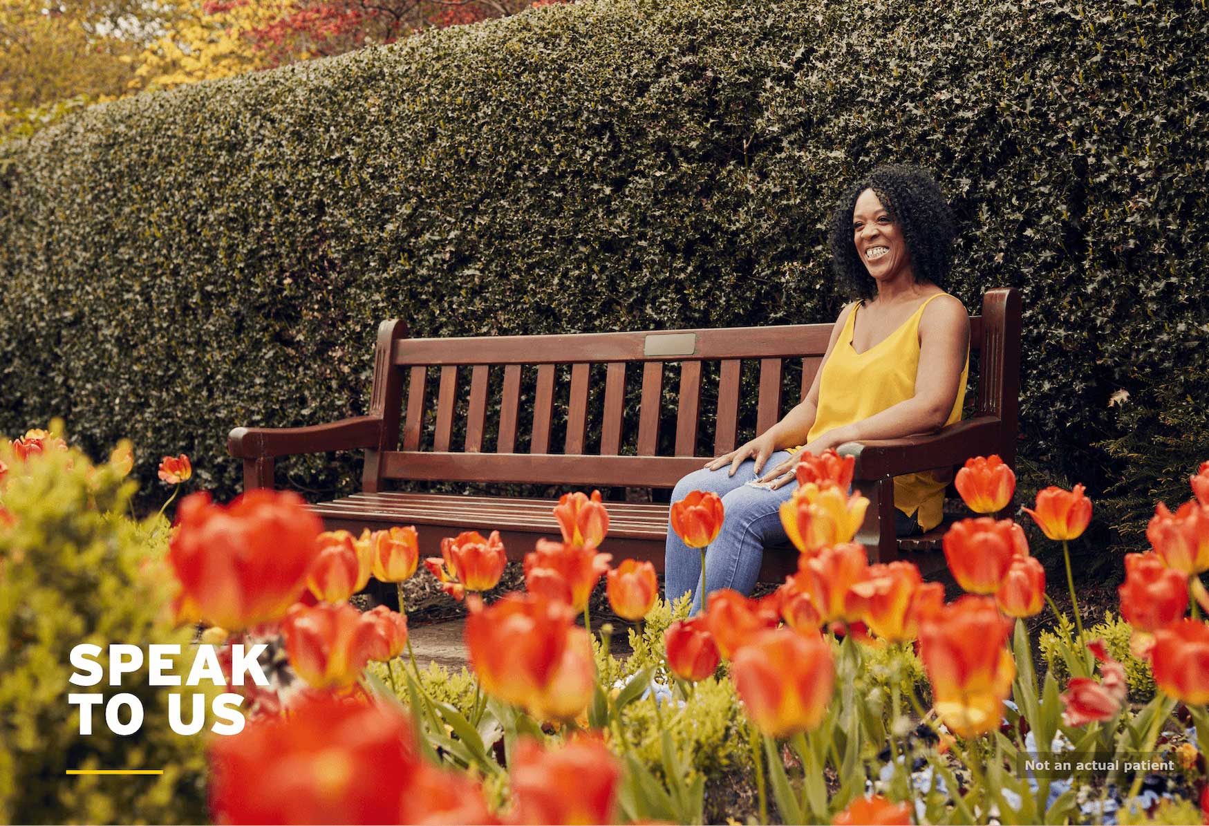 ICU/Surgery: lady in garden sat on wooden bench smiling