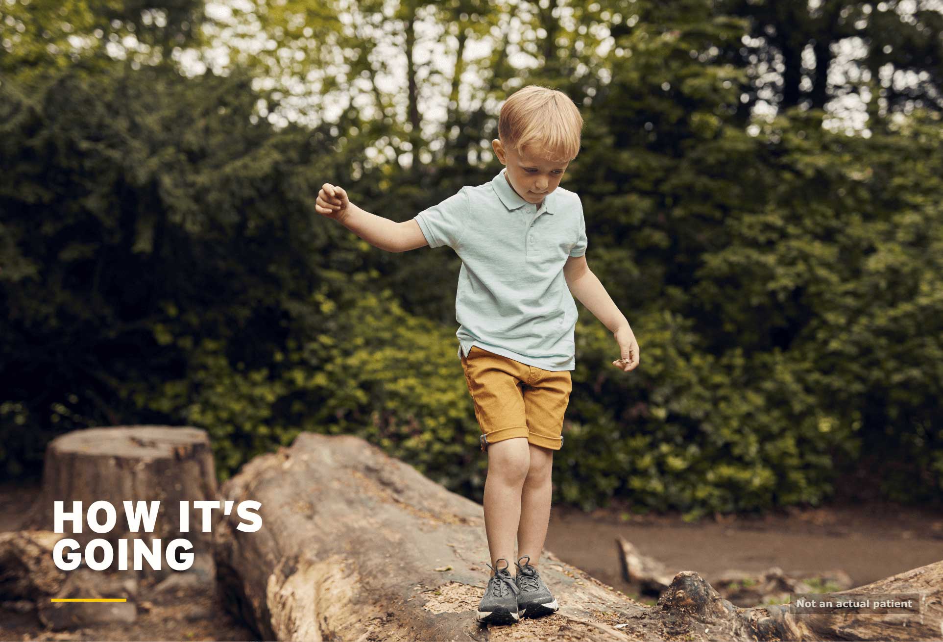 Neonates: boy balancing on fallen tree trunk