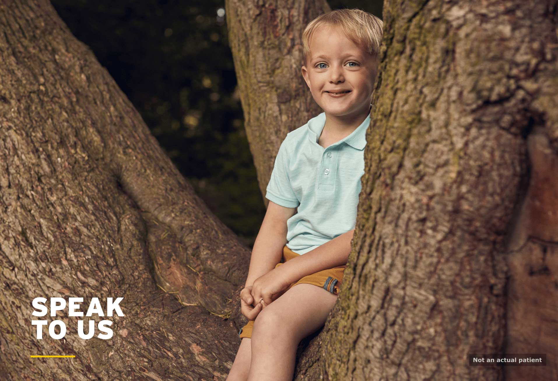 Neonates: boy sat in tree and smiling